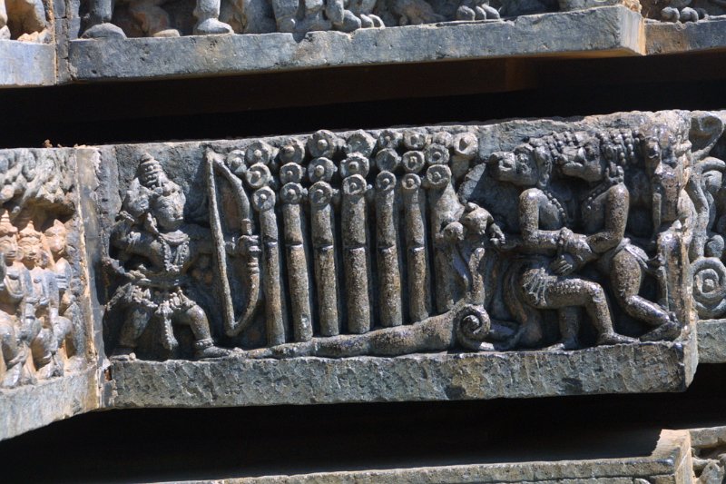 1495000_DetailsHalebiduTempleKarnataka.jpg - A God kills deamons with an arrow shot through the trees. Wall carving at the Hoysaleswara Temple, Halebidu