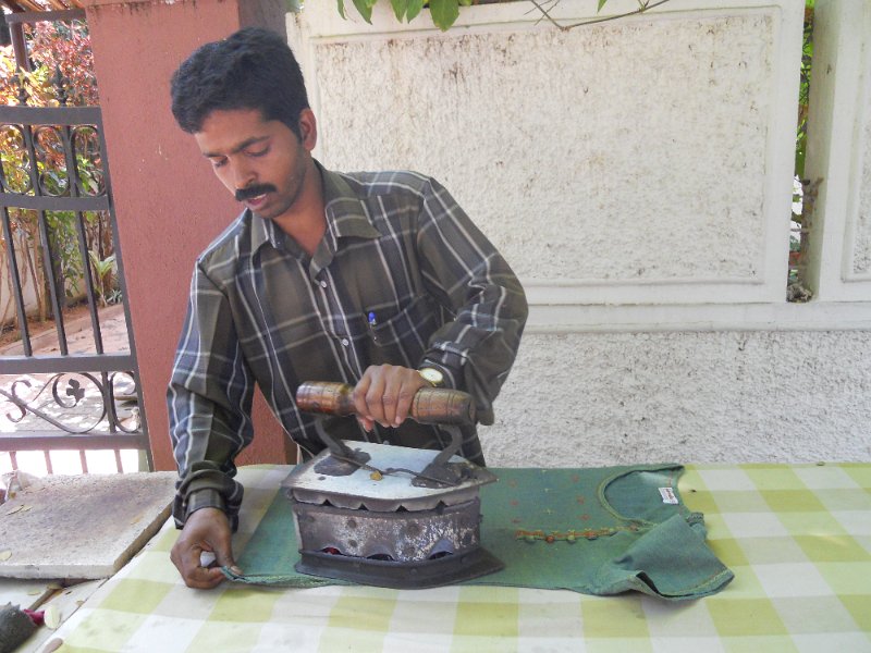 1549782_IroningClothesDefenceColony.jpg - Man ironing shirts on the street. Bangalore.