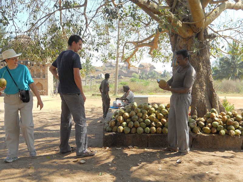 1302685_CocunutDrinkZenanaEnclosureHampi.jpg - Getting a coconut drink inside the Zenana Enclosure. Hampi.
