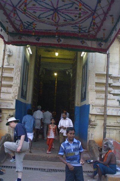 1667000_EnranceToKoodalAlagarTemple.jpg - Kathy removing her shoes at the entrance to the Koodal Alagar Temple. Madurai.