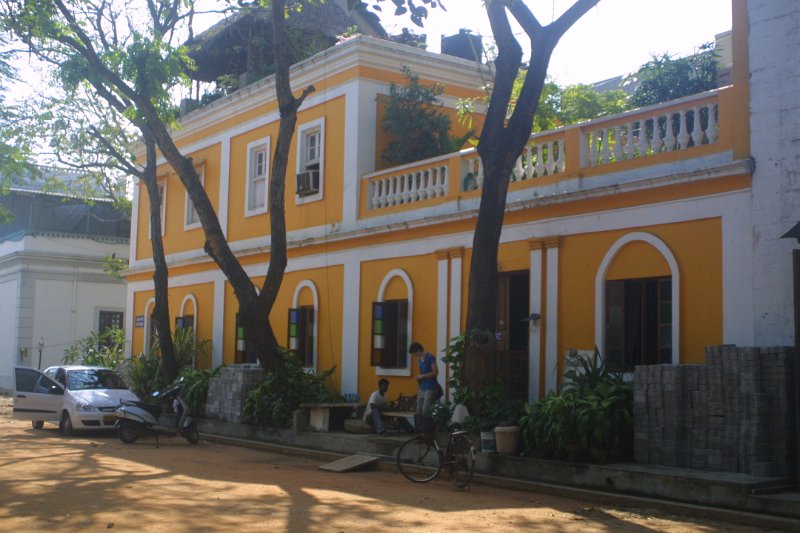 1899000_ManRefinishingFurnitureOutsideGuestHouse.jpg - Man refinishing furniture outside the guest house at Pondicherry.