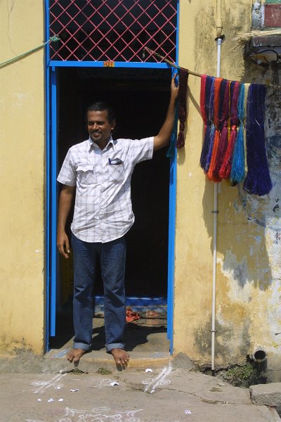 1802000_WeaverWithDyedSilk.jpg - The weaver with coloured silk drying. Darasuram.